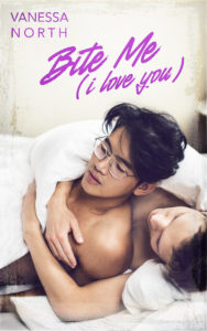 Book cover for Bite Me (i love you) by Vanessa North. The image shows two men in bed together, one a white man, the other an Asian man wearing glasses. The Asian man appears to be getting ready to leave the bed while the white man hugs him teasingly from behind. The title of the book and the author's name appear above the characters in purple script.